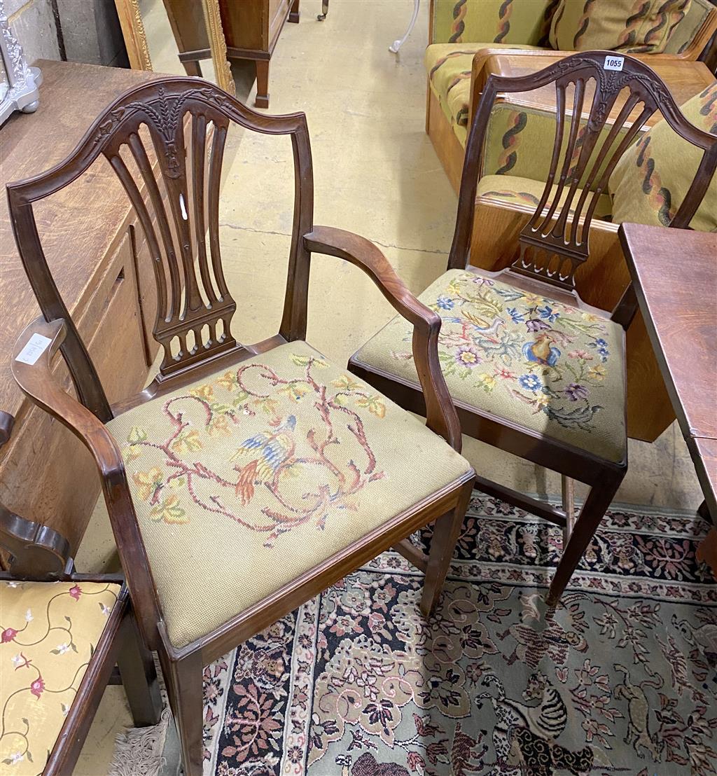 A set of six Hepplewhite style mahogany shield back dining chairs with tapestry drop in seats (two with arms)
